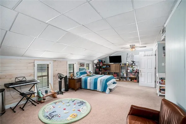 a view of a livingroom with furniture and a flat screen tv