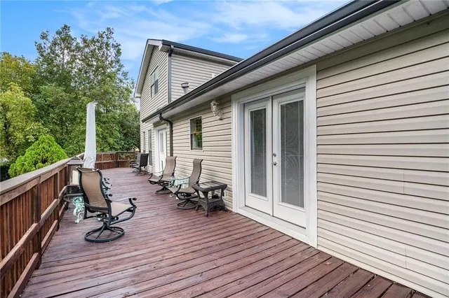 a view of deck with seating space and wooden floor