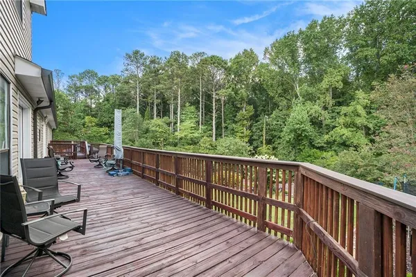 a view of balcony with furniture and wooden deck