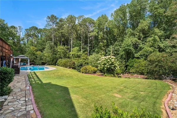 a view of a backyard with swimming pool