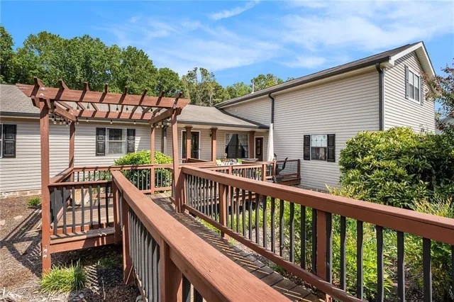 a view of a house with wooden deck and furniture