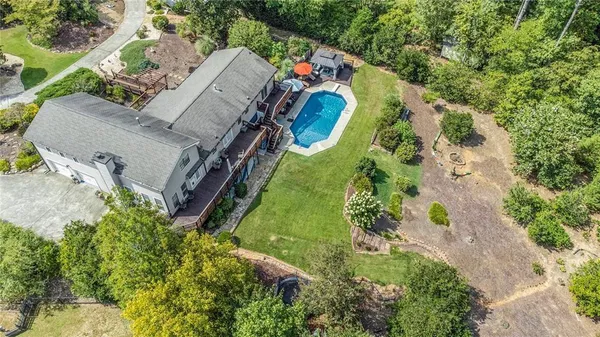 an aerial view of a house with a yard and a garage