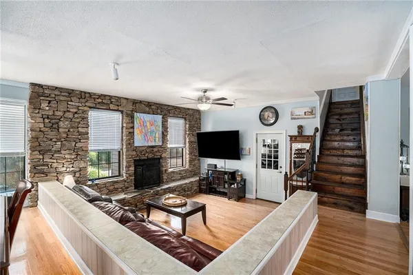 a living room with furniture flat screen tv and a fireplace