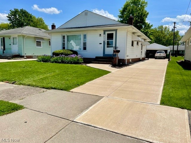 28634 Forest Road Willowick, OH 44095 - Photo 1 of 39 White siding exterior with a pitched roof, featuring a concrete driveway and an attached garage