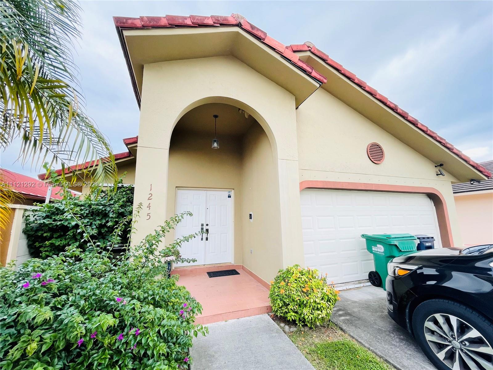 1245 Southwest 143rd Place Miami, FL 33184 - Photo 1 of 23 a front view of a house with parking