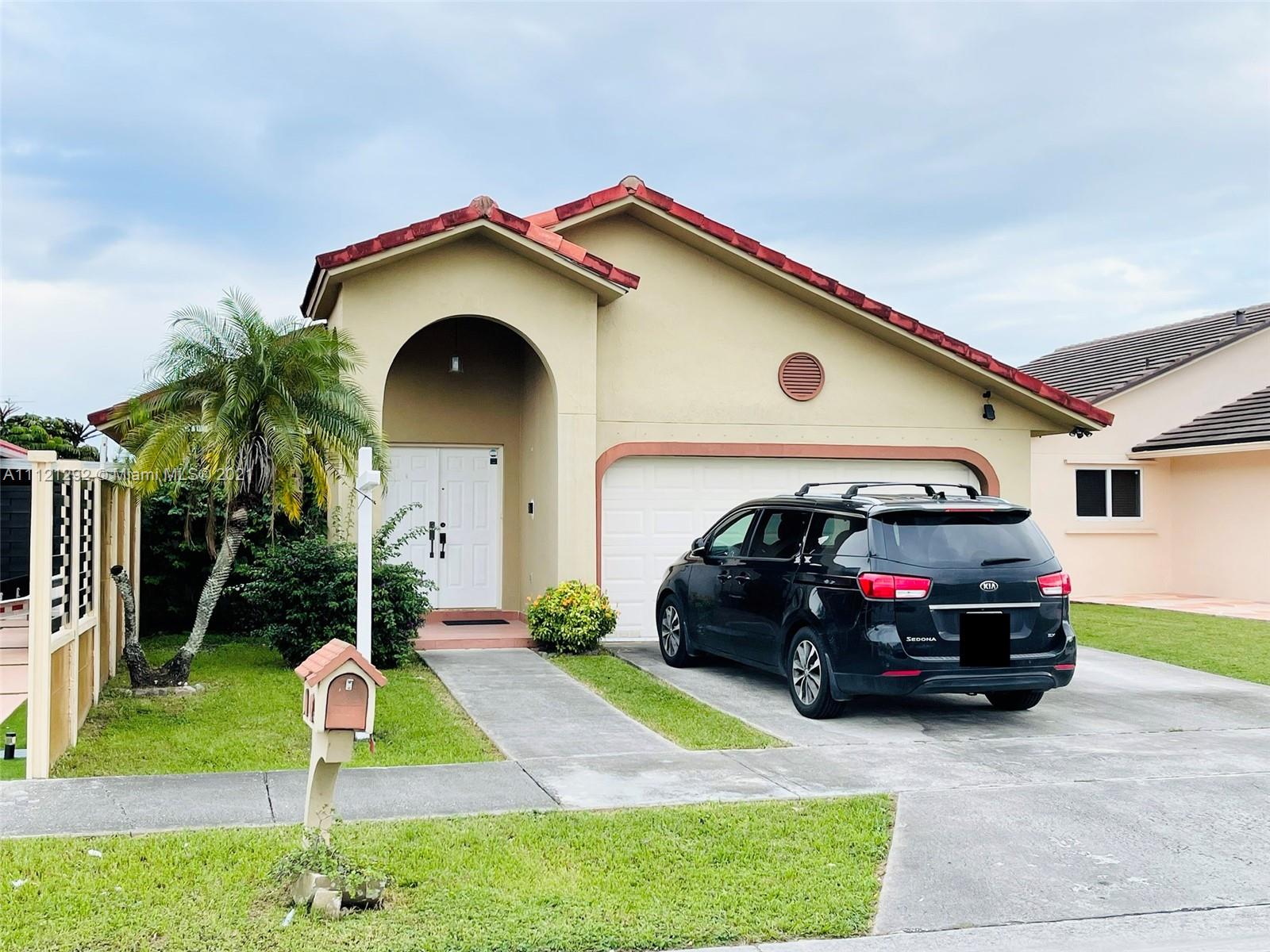 1245 Southwest 143rd Place Miami, FL 33184 - Photo 2 of 23 a car parked in front of a house