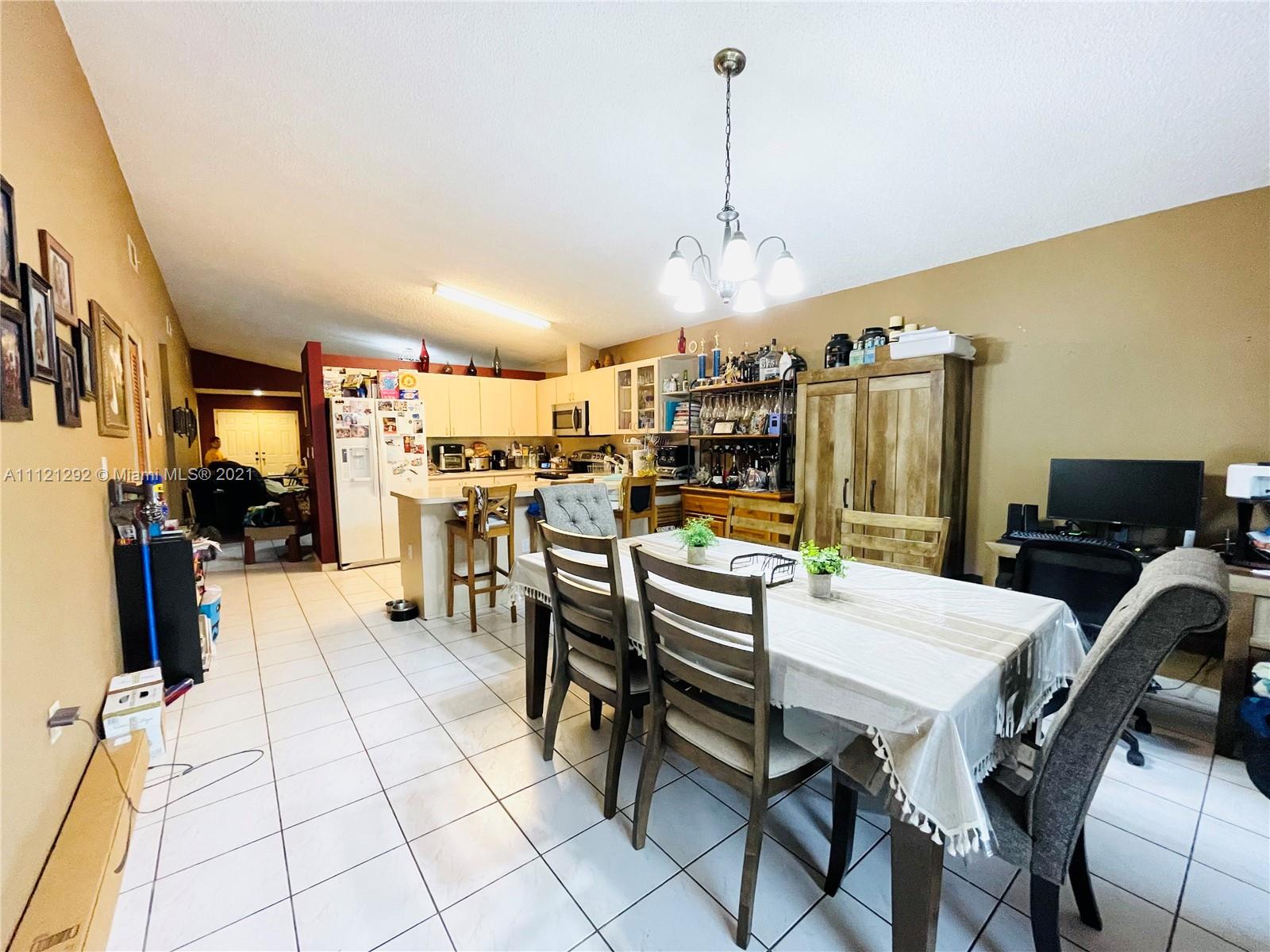 1245 Southwest 143rd Place Miami, FL 33184 - Photo 11 of 23 a view of a dining room with furniture