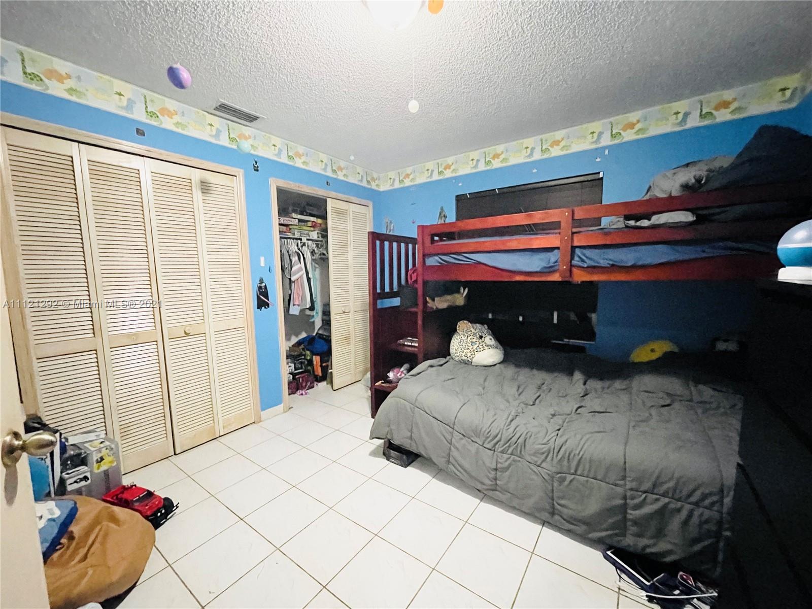 1245 Southwest 143rd Place Miami, FL 33184 - Photo 12 of 23 a bedroom with a bed and a window