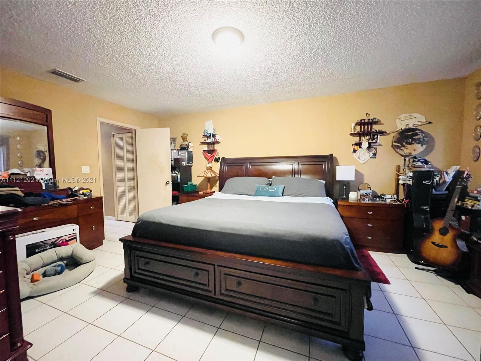 1245 Southwest 143rd Place Miami, FL 33184 - Photo 14 of 23 a bed room with a bed and a chair