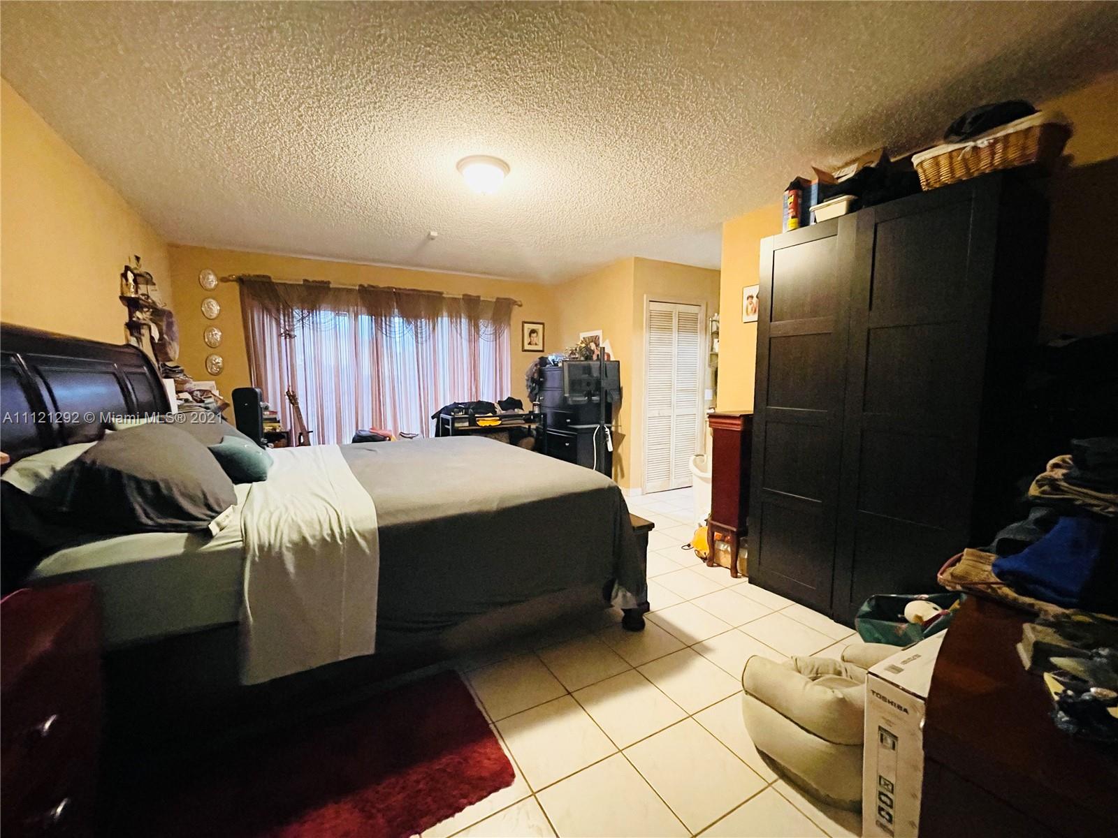 1245 Southwest 143rd Place Miami, FL 33184 - Photo 15 of 23 a bed room with a bed and a television