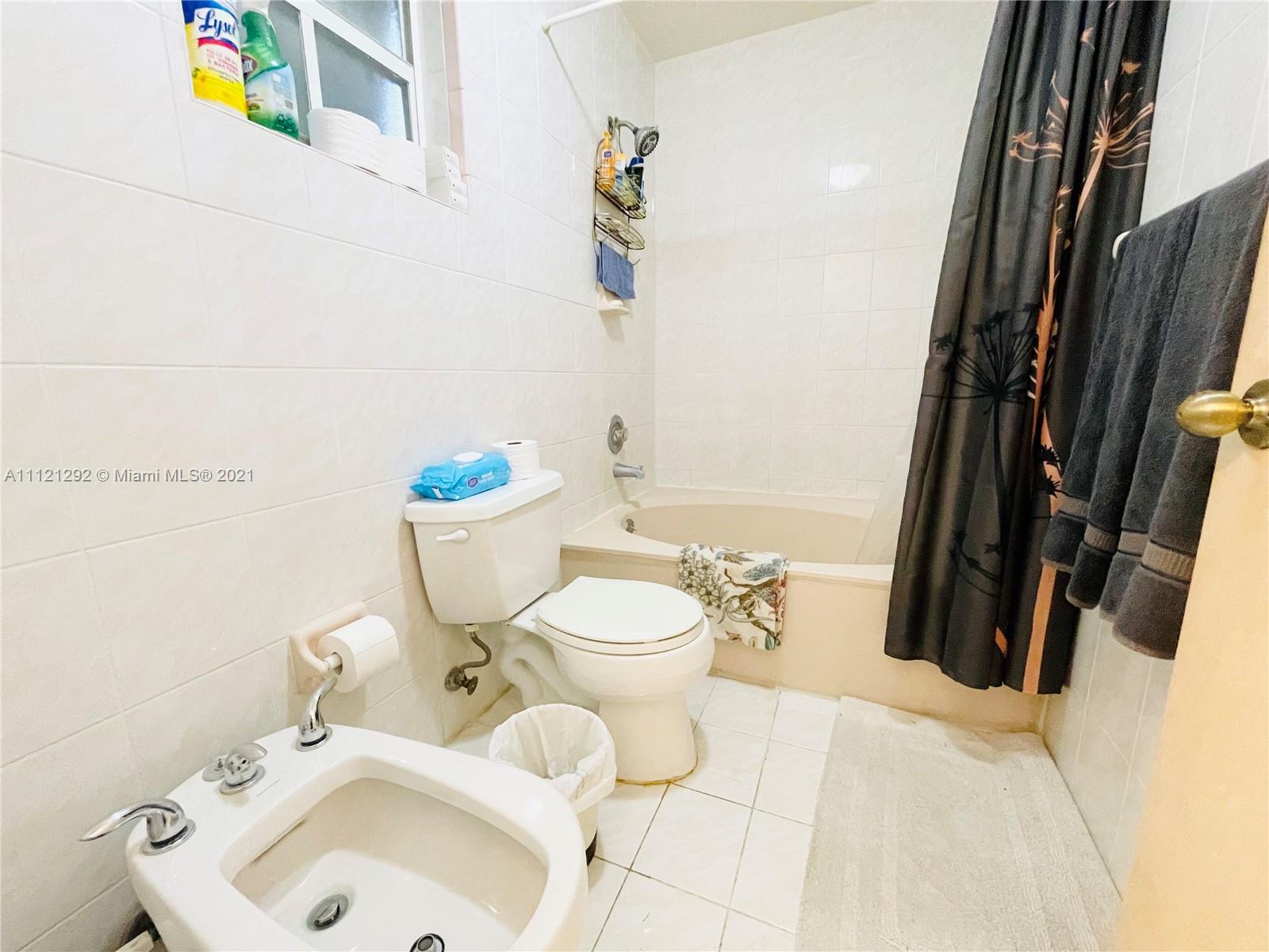 1245 Southwest 143rd Place Miami, FL 33184 - Photo 17 of 23 a bathroom with a sink a toilet and a mirror