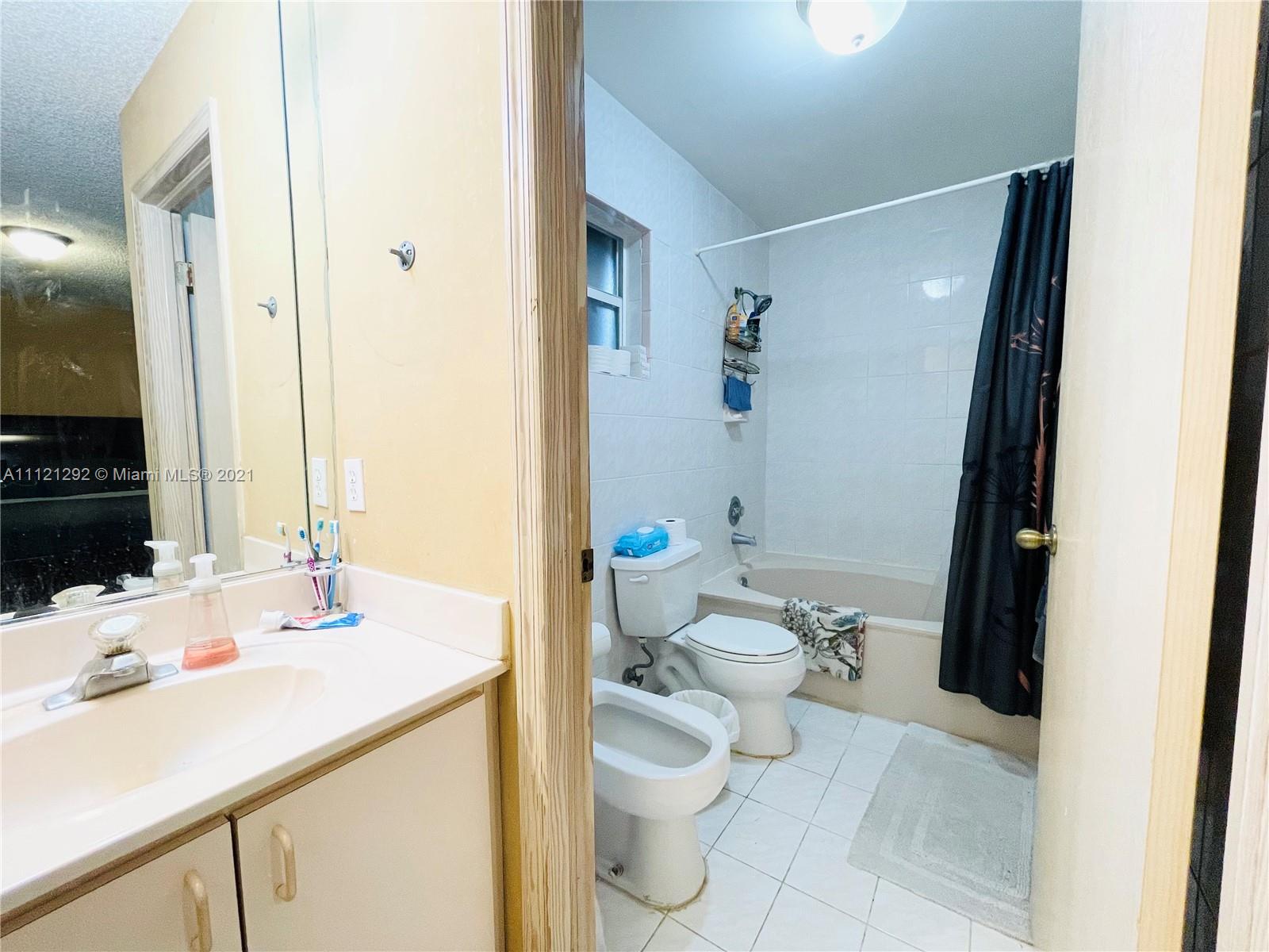 1245 Southwest 143rd Place Miami, FL 33184 - Photo 18 of 23 a bathroom with a sink toilet and shower