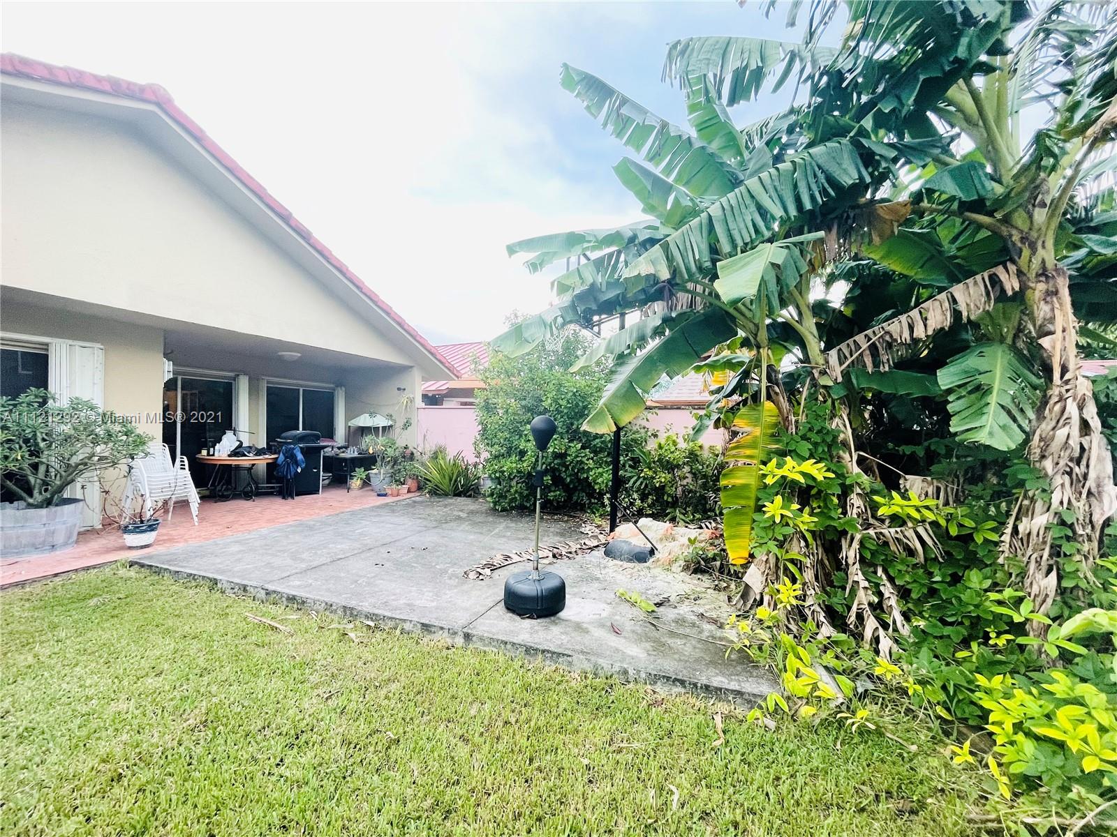1245 Southwest 143rd Place Miami, FL 33184 - Photo 20 of 23 a view of a backyard with plants and a garden