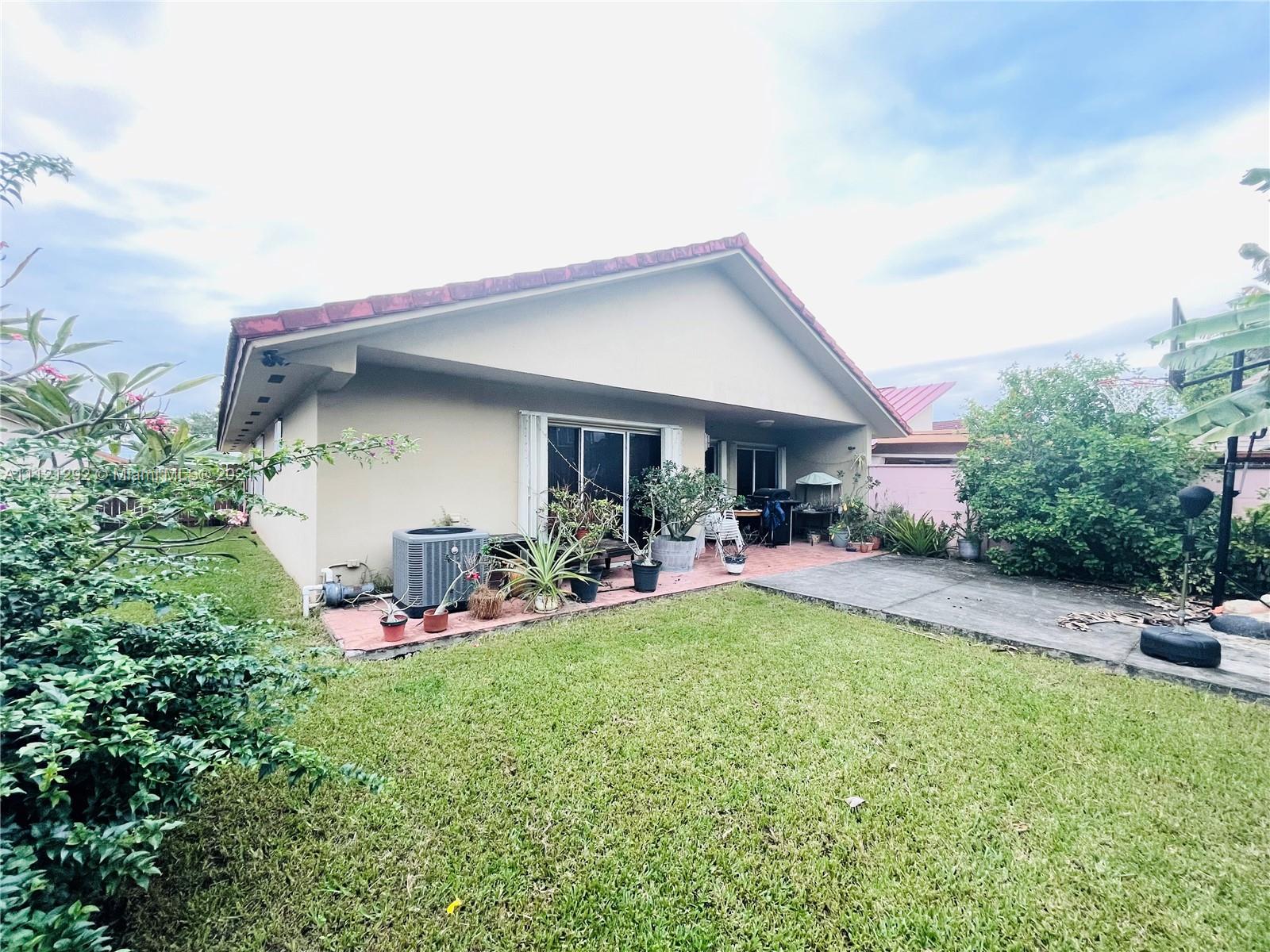 1245 Southwest 143rd Place Miami, FL 33184 - Photo 23 of 23 a view of a backyard with sitting area and garden