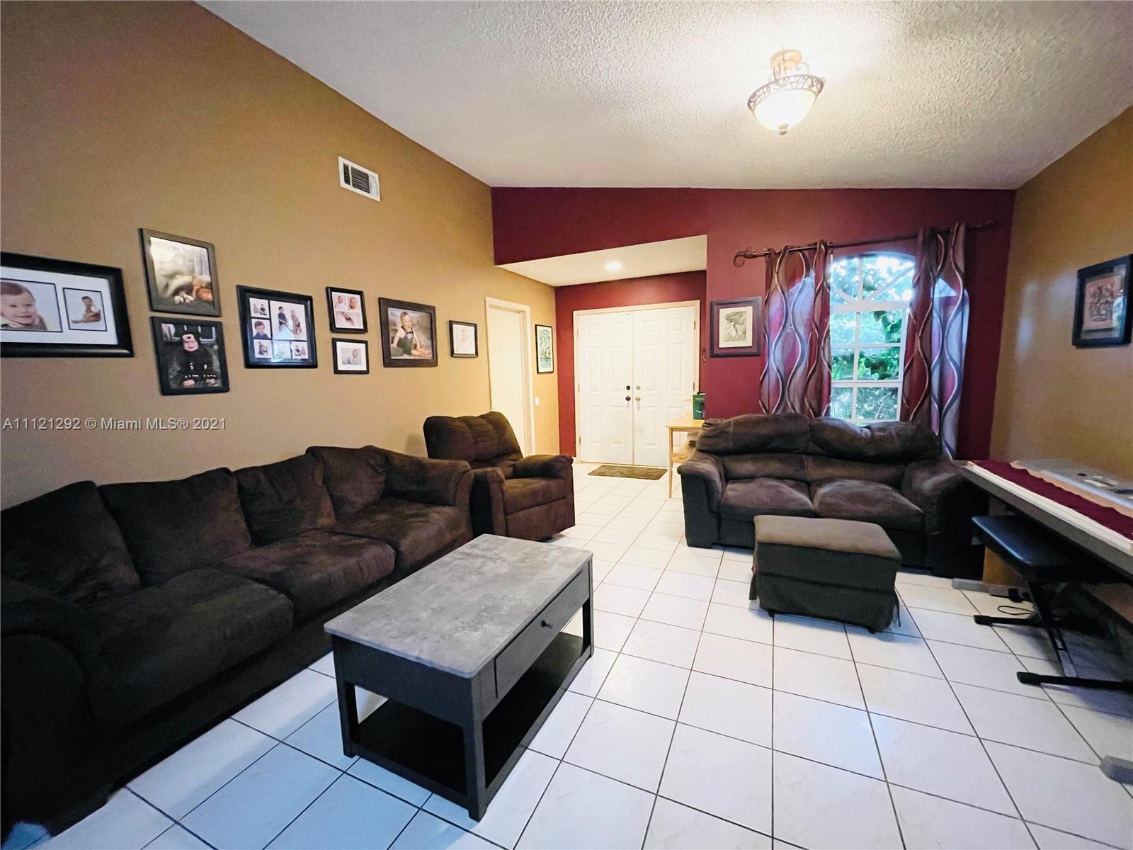 1245 Southwest 143rd Place Miami, FL 33184 - Photo 5 of 23 a living room with furniture and a rug