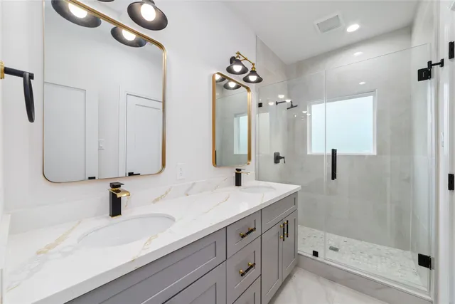 a bathroom with a sink bath tub and shower