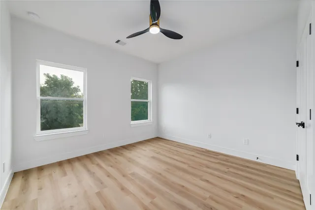 wooden floor in an empty room with a window