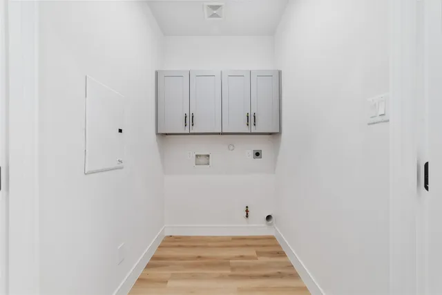 a view of a room with wooden floor