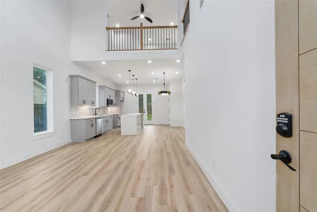 a view of a kitchen with wooden floor and windows