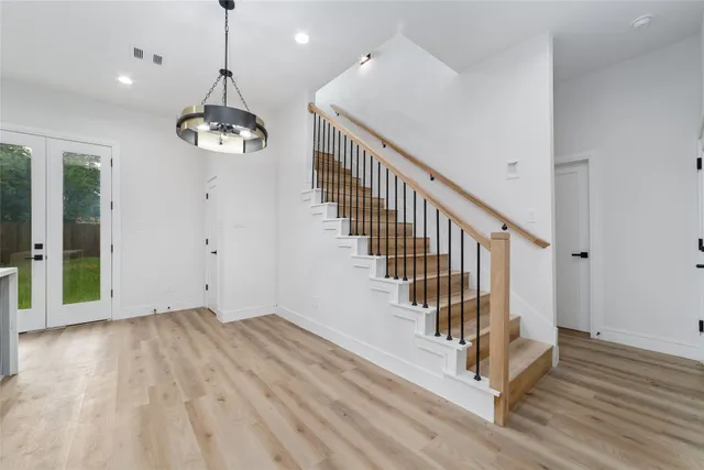a view of a room with wooden floor and stairs