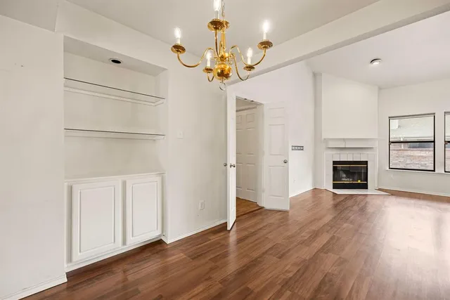 a view of a room with wooden floor and window