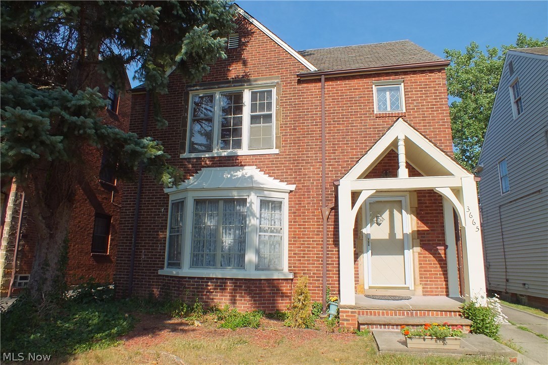 Front view of this fine brick two-family home with freshly painted trim