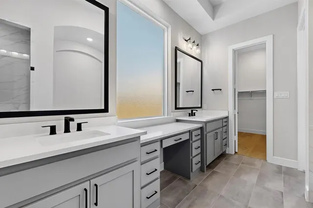 a bathroom with a double vanity sink mirror and
