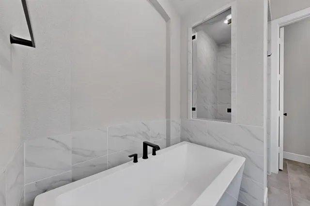 a bathroom with a bathtub and shower