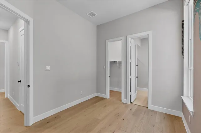 a bathroom with a sink a toilet a mirror and shower