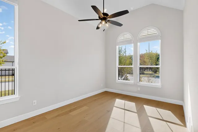 a view of a livingroom with a ceiling fan and wooden floor