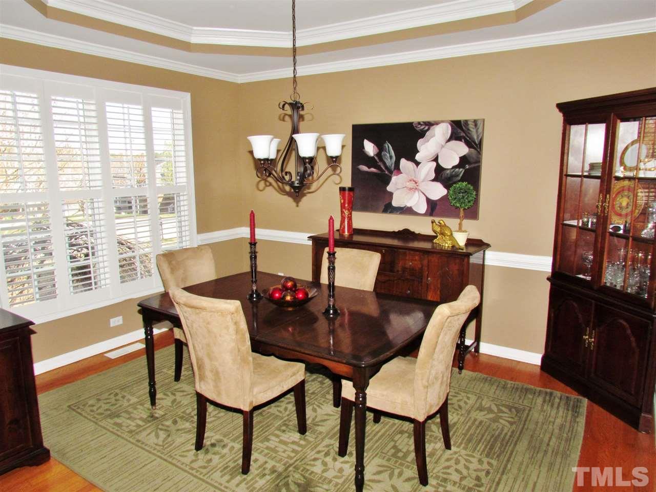 101 Mickleson Ridge Drive Raleigh, NC 27603 - Photo 1 of 25 a dining room with furniture a rug and a large window