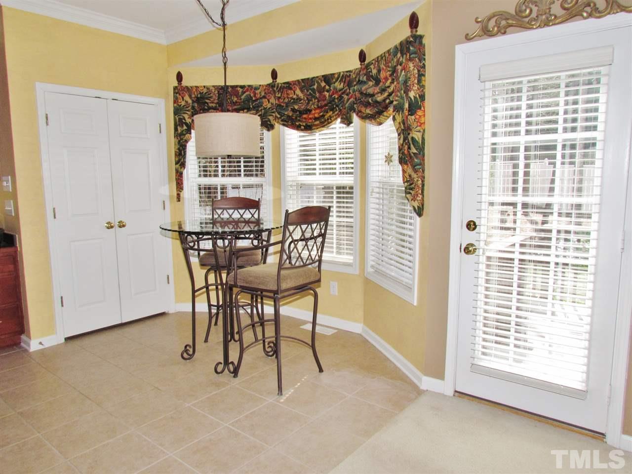 101 Mickleson Ridge Drive Raleigh, NC 27603 - Photo 9 of 25 a view of a dining room with furniture window and outside view