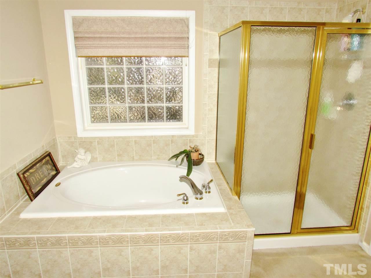 101 Mickleson Ridge Drive Raleigh, NC 27603 - Photo 12 of 25 a white bath tub sitting next to a window
