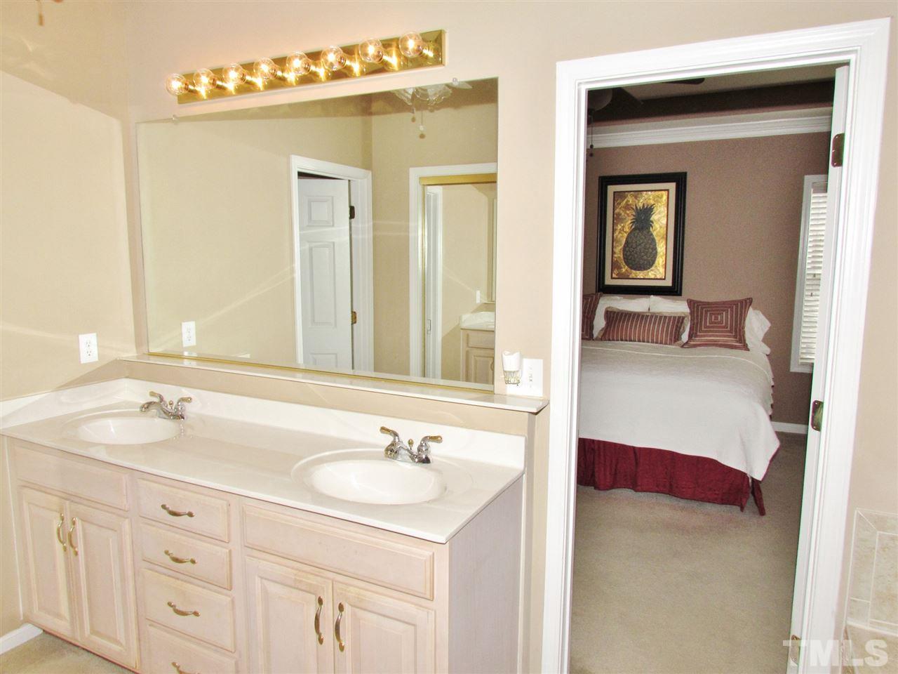 101 Mickleson Ridge Drive Raleigh, NC 27603 - Photo 13 of 25 a en suite bathroom with 2 sink and a mirror