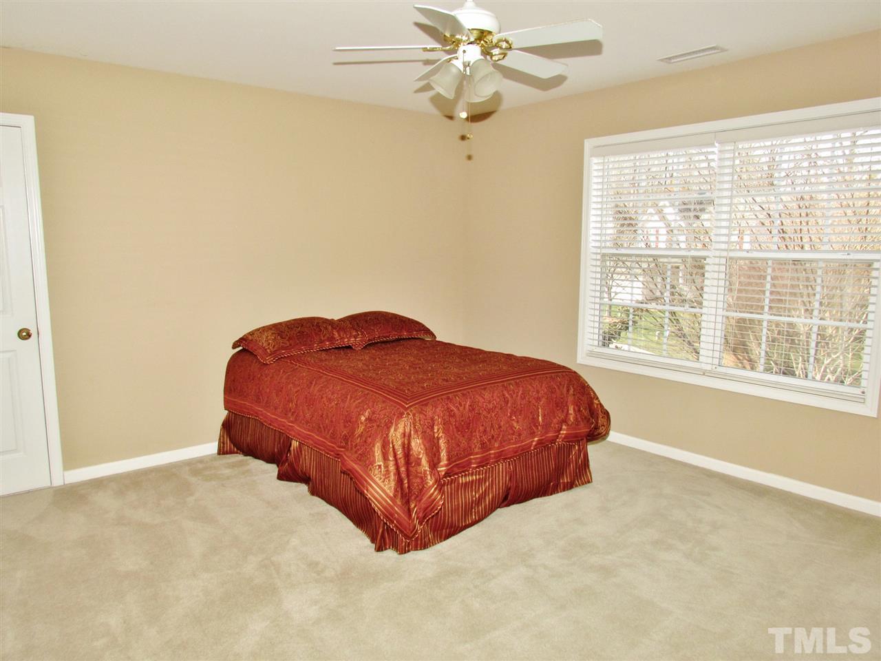 101 Mickleson Ridge Drive Raleigh, NC 27603 - Photo 14 of 25 a bed sitting in a bedroom next to a window