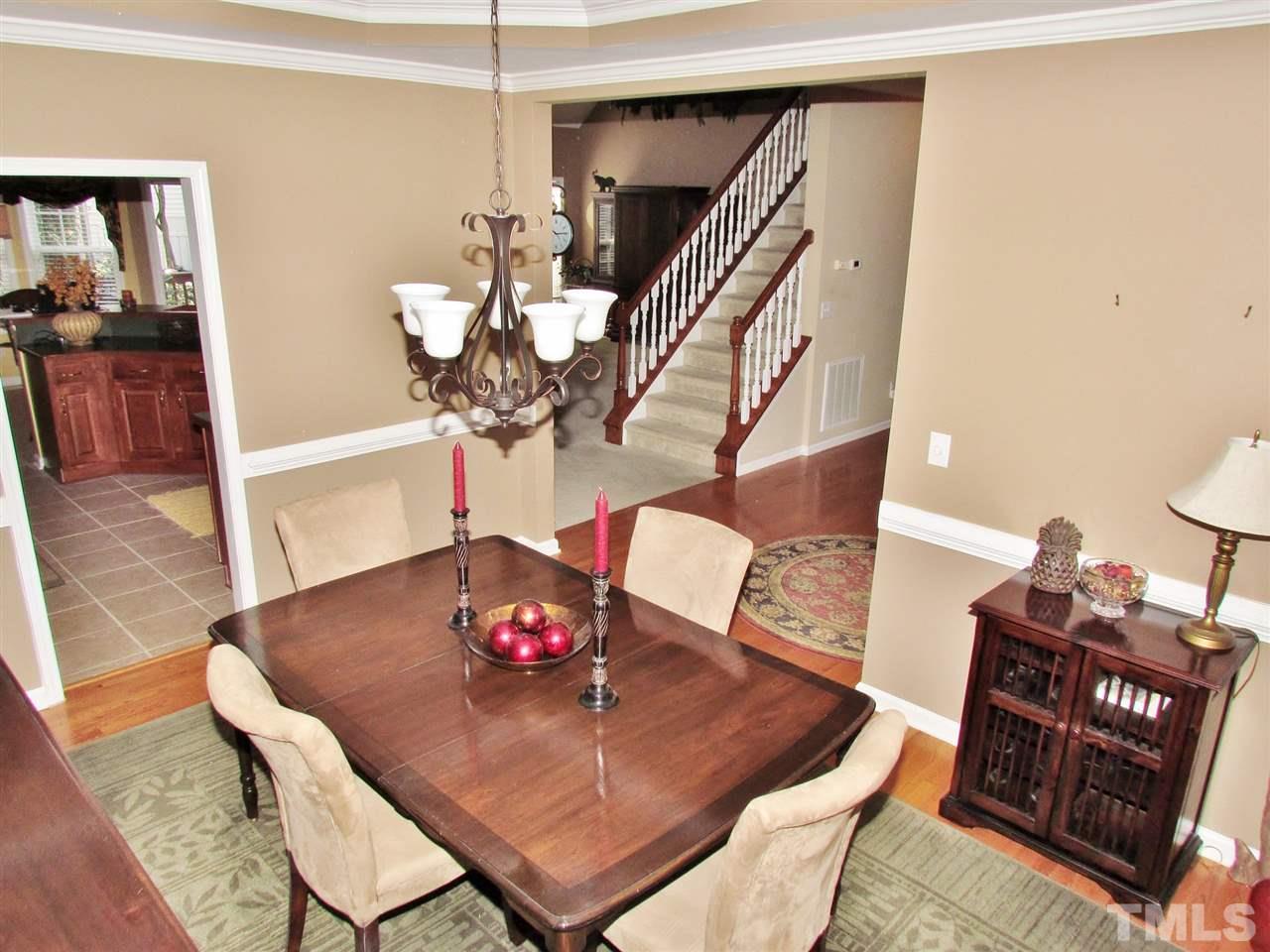 101 Mickleson Ridge Drive Raleigh, NC 27603 - Photo 2 of 25 a view of a dining room with furniture and wooden floor