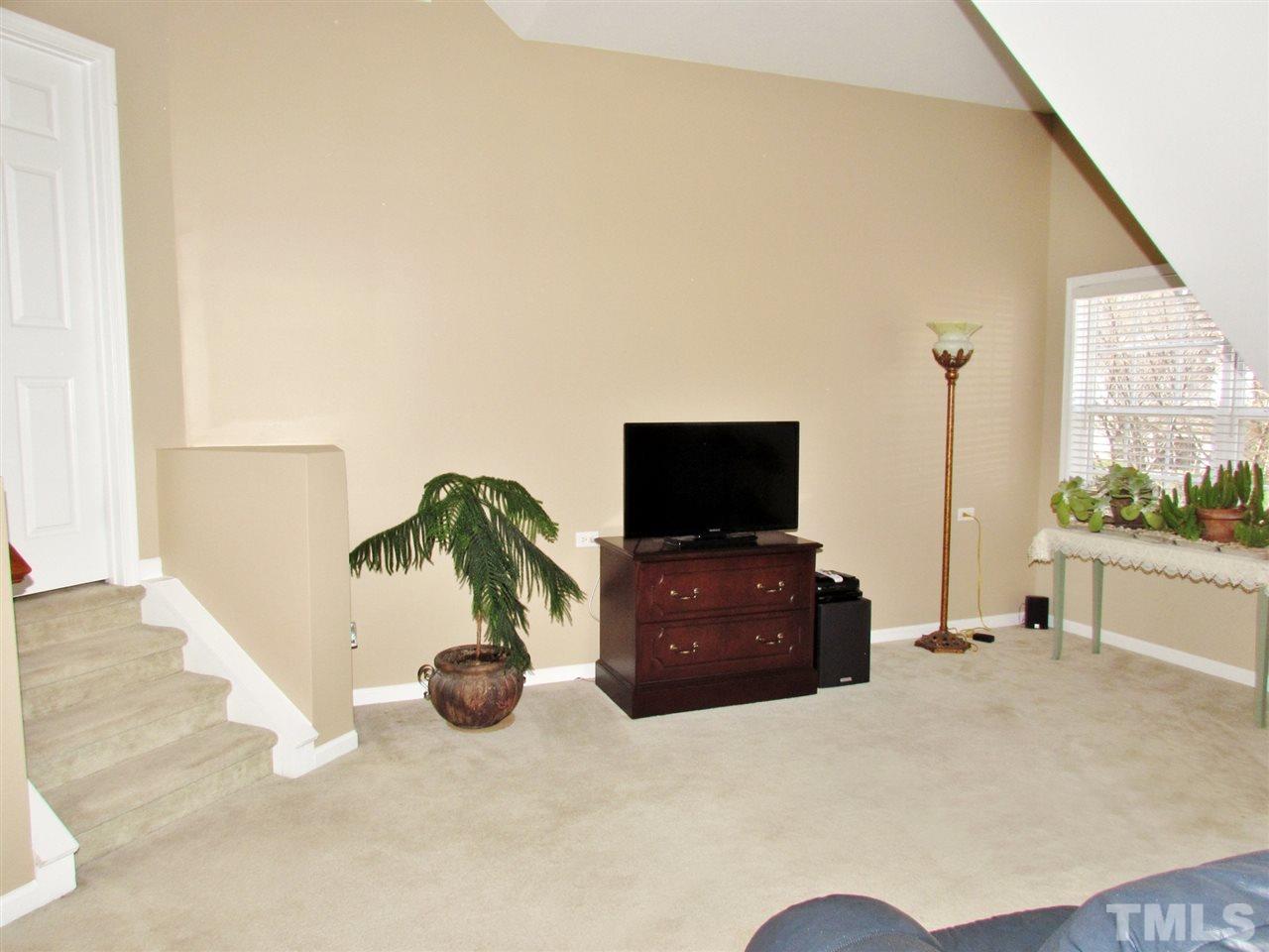 101 Mickleson Ridge Drive Raleigh, NC 27603 - Photo 19 of 25 a living room with furniture and a flat screen tv