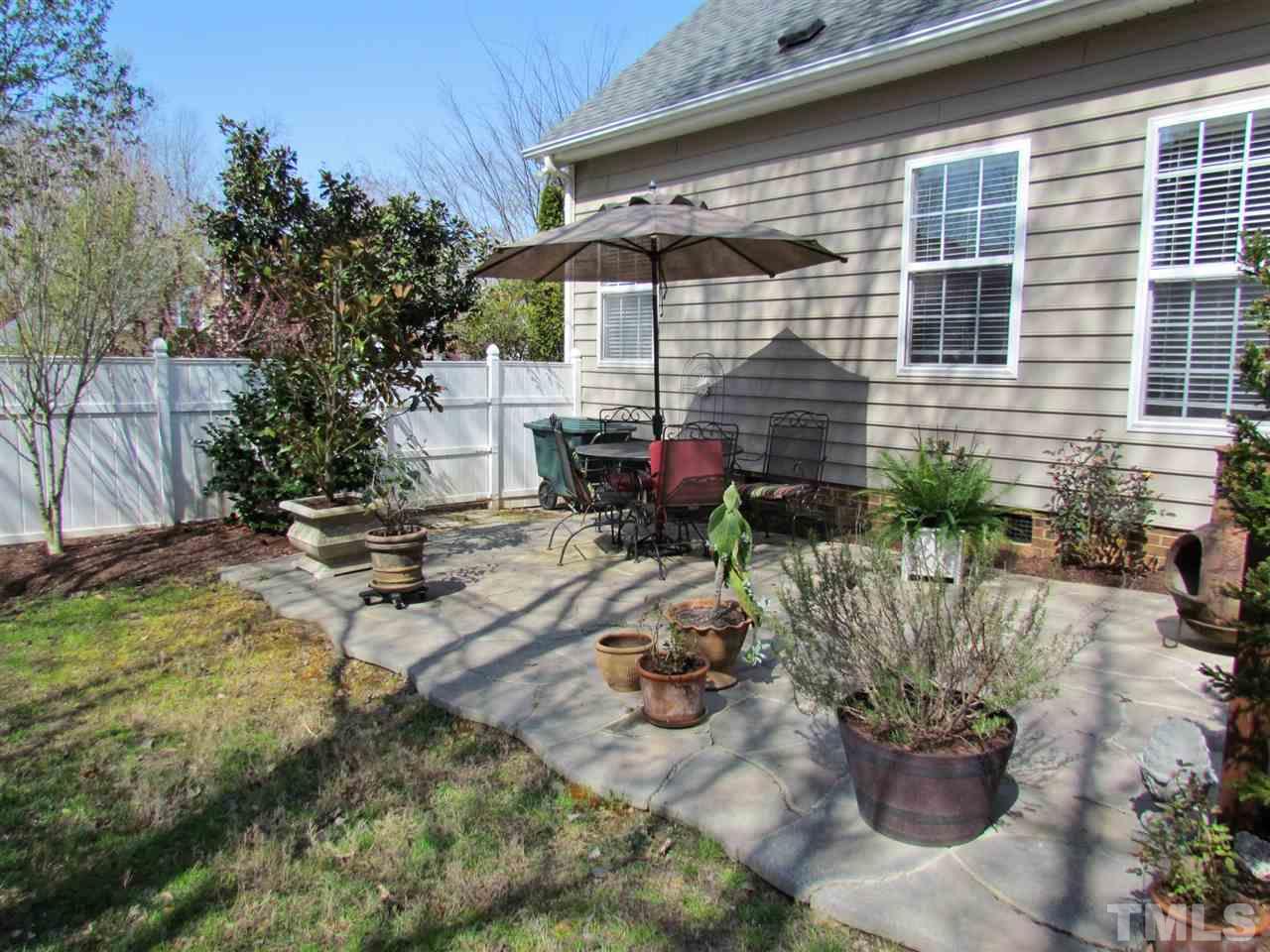 101 Mickleson Ridge Drive Raleigh, NC 27603 - Photo 20 of 25 a backyard of a house with yard and outdoor seating