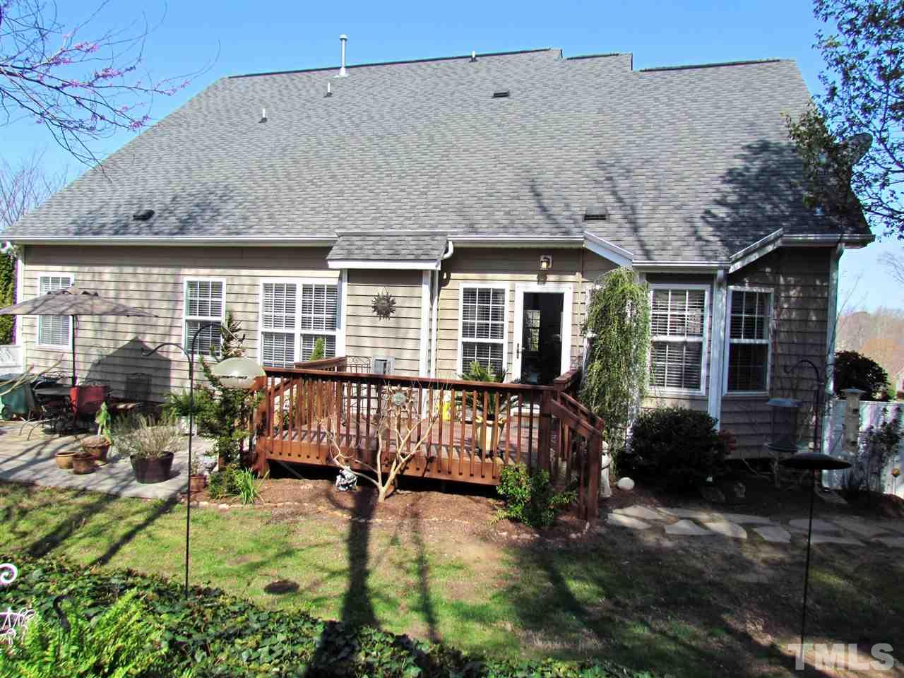 101 Mickleson Ridge Drive Raleigh, NC 27603 - Photo 21 of 25 a backyard of a house with yard table and chairs