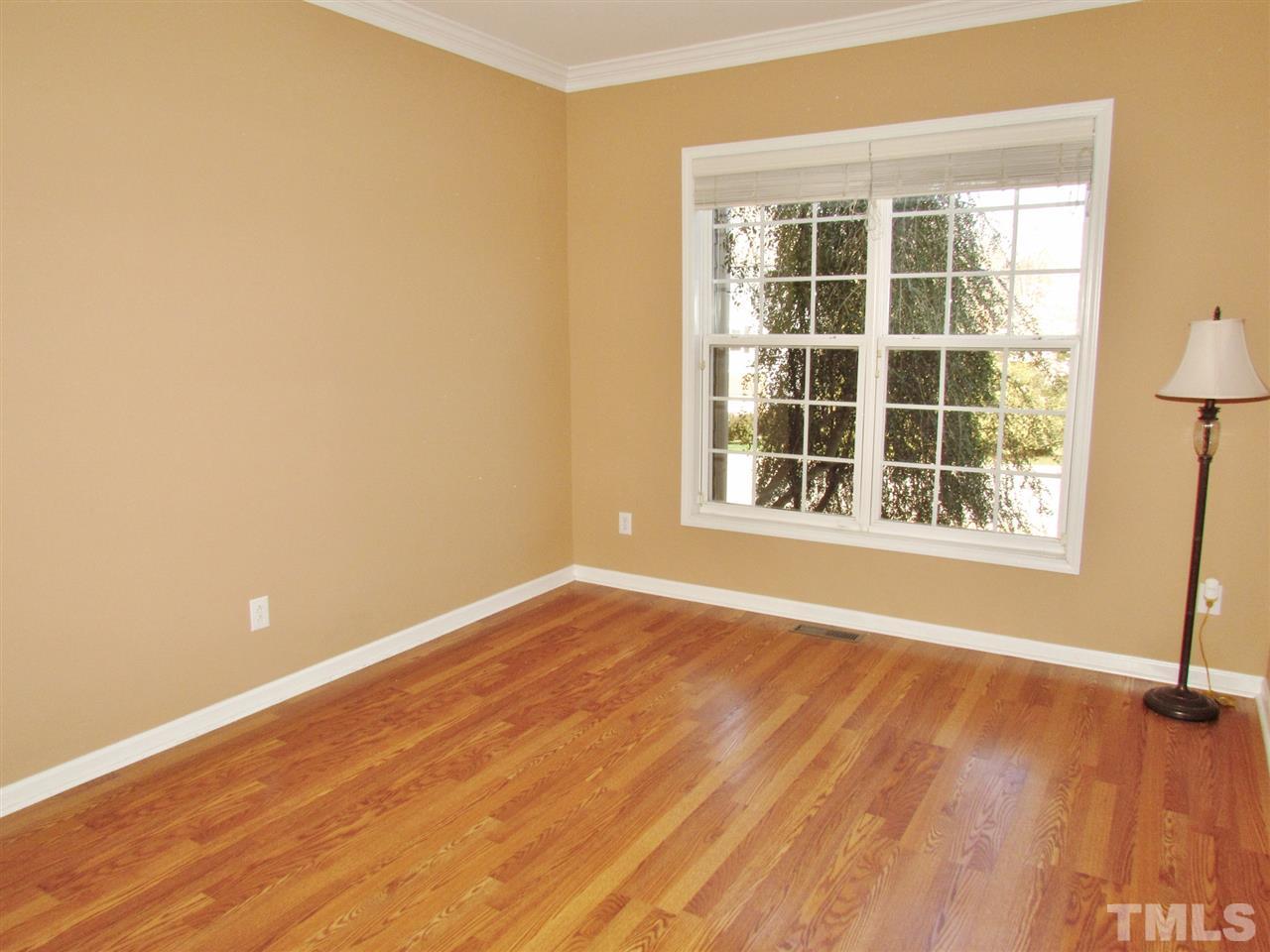 101 Mickleson Ridge Drive Raleigh, NC 27603 - Photo 3 of 25 a view of an empty room with wooden floor and a window