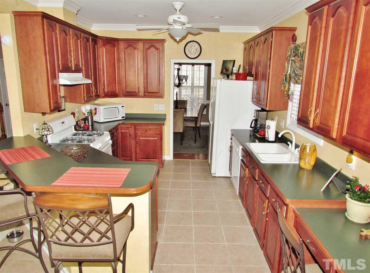 101 Mickleson Ridge Drive Raleigh, NC 27603 - Photo 6 of 25 a kitchen with a sink stove and cabinets