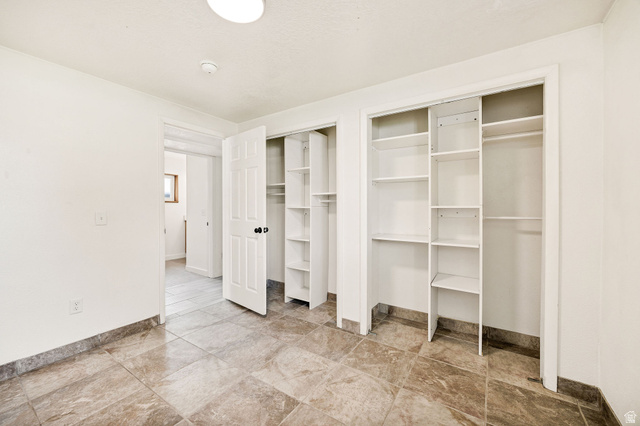 365 South Center Street Fielding, UT 84311 - Photo 25 of 41 Unfurnished bedroom featuring multiple closets and baseboards