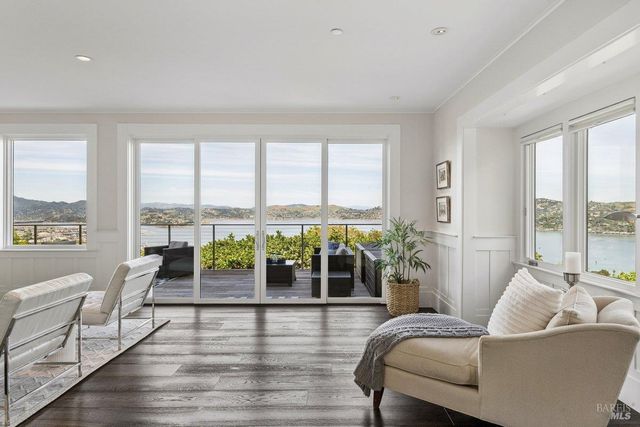 a living room with furniture and floor to ceiling windows