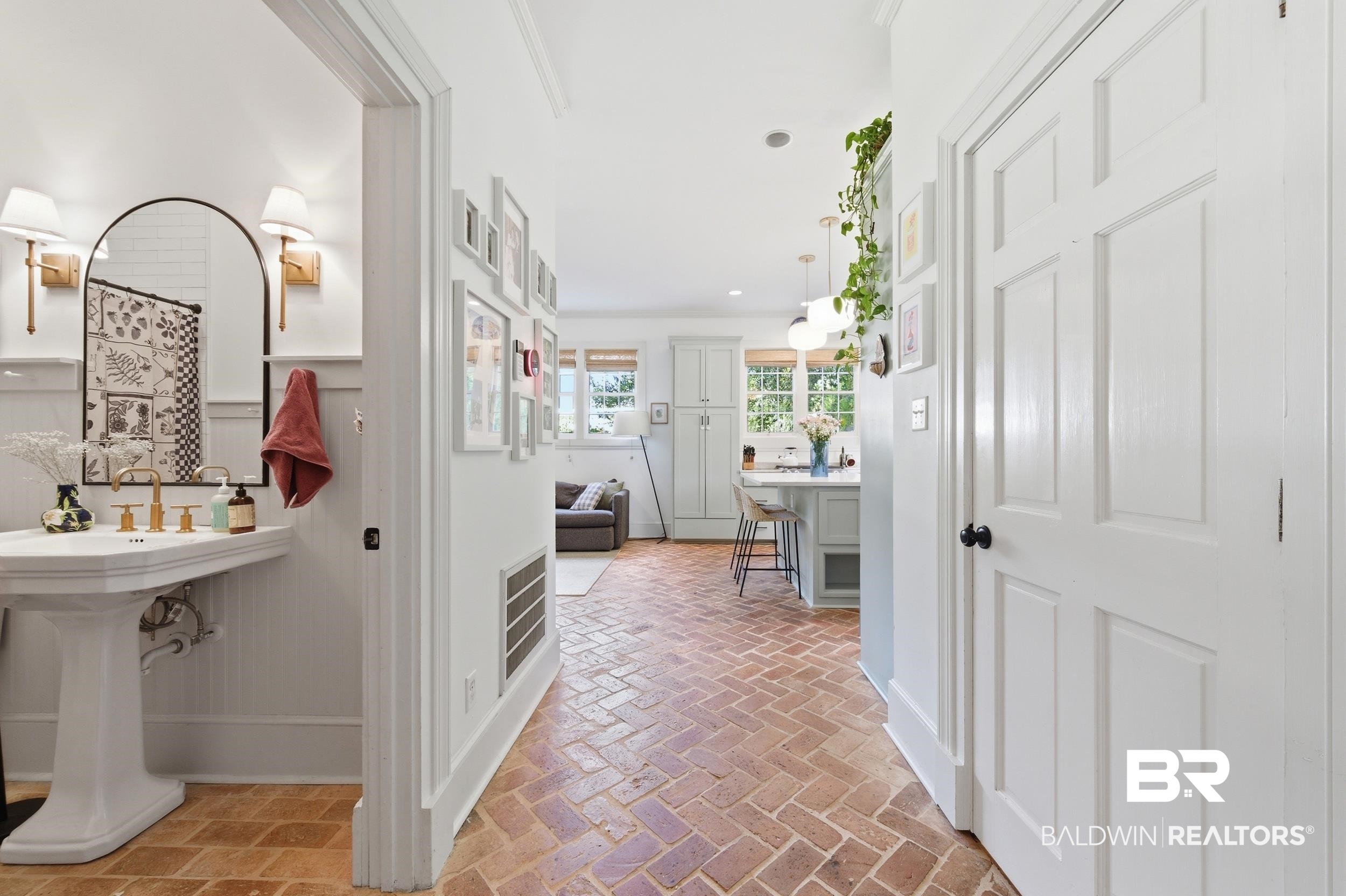 350 Charles Street Mobile, AL 36604 - Photo 26 of 52 Herringbone brick flooring in a corridor featuring a panel door and a bathroom entry