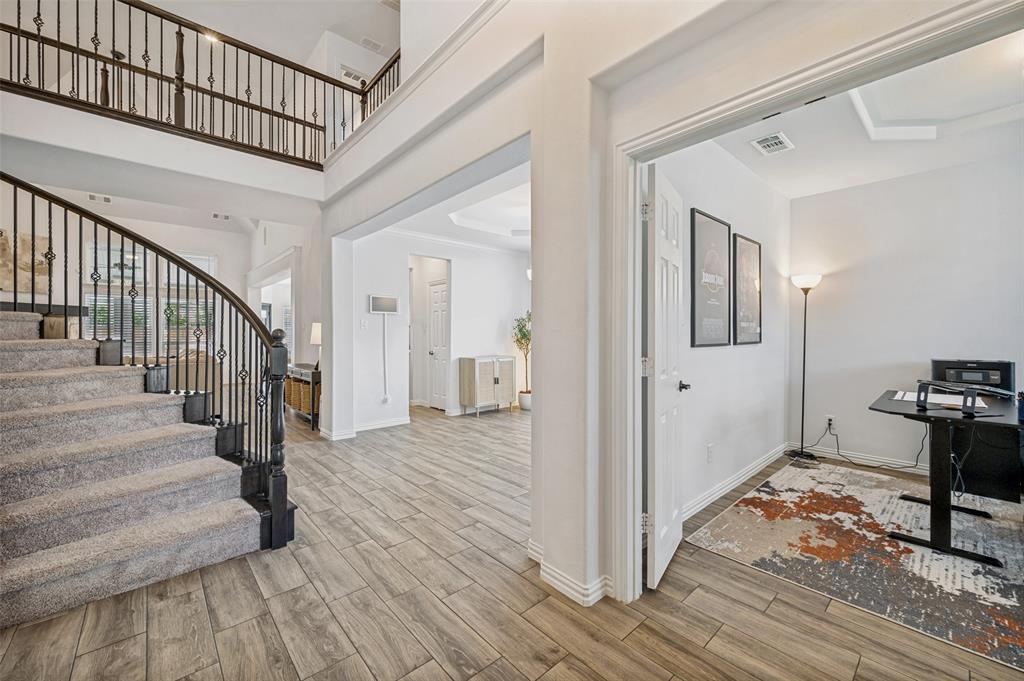 808 Violet Way Celina, TX 75009 - Photo 2 of 30 Gorgeous entry, spiral staircase leading upstairs with upgraded railing.