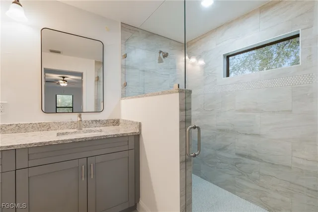 a bathroom with a granite countertop sink mirror and double