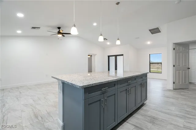 a bathroom with a granite countertop sink a toilet and a mirror