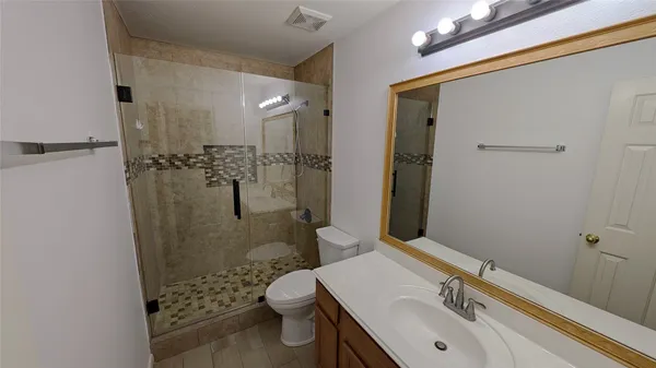 a bathroom with a sink toilet and shower