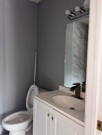 a bathroom with a sink toilet and vanity