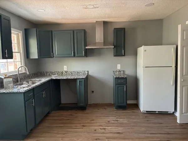 a kitchen with a refrigerator and a sink